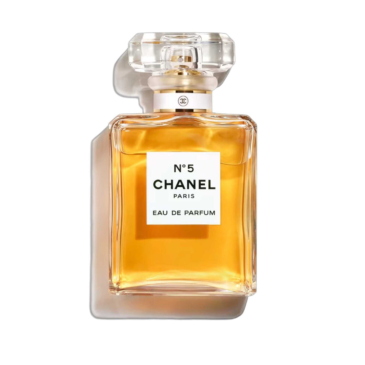 Chanel N°5 Eau de Parfum 100ml bottle showcasing its timeless floral-aldehyde elegance in a classic rectangular glass design with golden amber liquid.